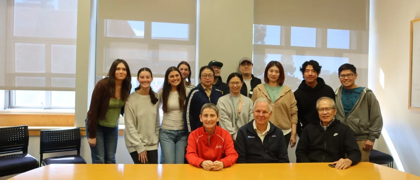 Photograph of lab members in a conference room